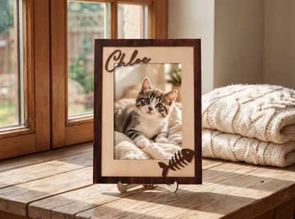 A rectangular wooden picture frame with a dark brown outer border and a light beige inner border. The name Chloe is cut out in dark wood at the top left, and a dark wooden fish skeleton icon is attached at the bottom right corner.