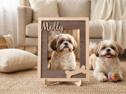 A rectangular wooden picture frame with a light wood outer border and a dark wood inner frame. The name Molly is cut out in script lettering at the top, and a bone-shaped cutout is at the bottom right corner of the frame.