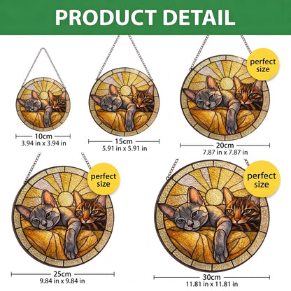 Five circular stained glass suncatchers featuring two cats resting against a sunburst background. Sizes range from 3.94 inches to 11.81 inches in diameter. Each piece includes a hanging chain and displays a warm yellow and brown color palette.