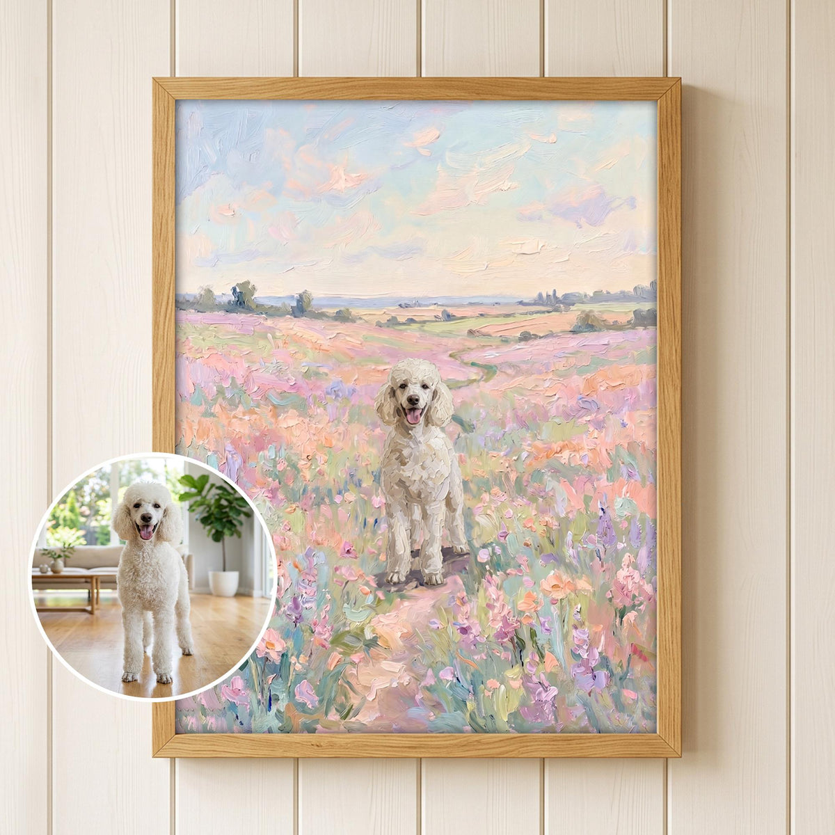 A framed oil painting featuring a white poodle standing in a vibrant field of pink, purple, and orange wildflowers under a soft pastel sky. A circular inset shows a photograph of the same white poodle standing on a wooden floor.