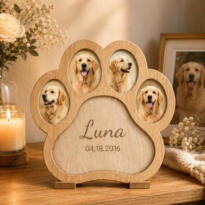 A light-colored wooden paw-shaped picture frame featuring four oval photo slots, each displaying a golden retriever. The center of the frame is engraved with the name Luna and the date 04.18.2016 in a cursive and sans-serif font.