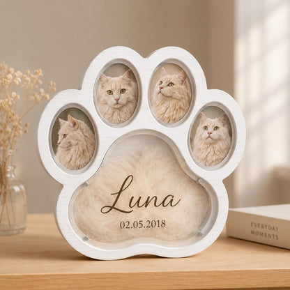 A white paw-shaped wooden frame featuring three oval photo slots containing pictures of a fluffy cat. The large central section displays the name Luna and the date 02.05.2018 in dark brown script and sans-serif lettering on a beige background.