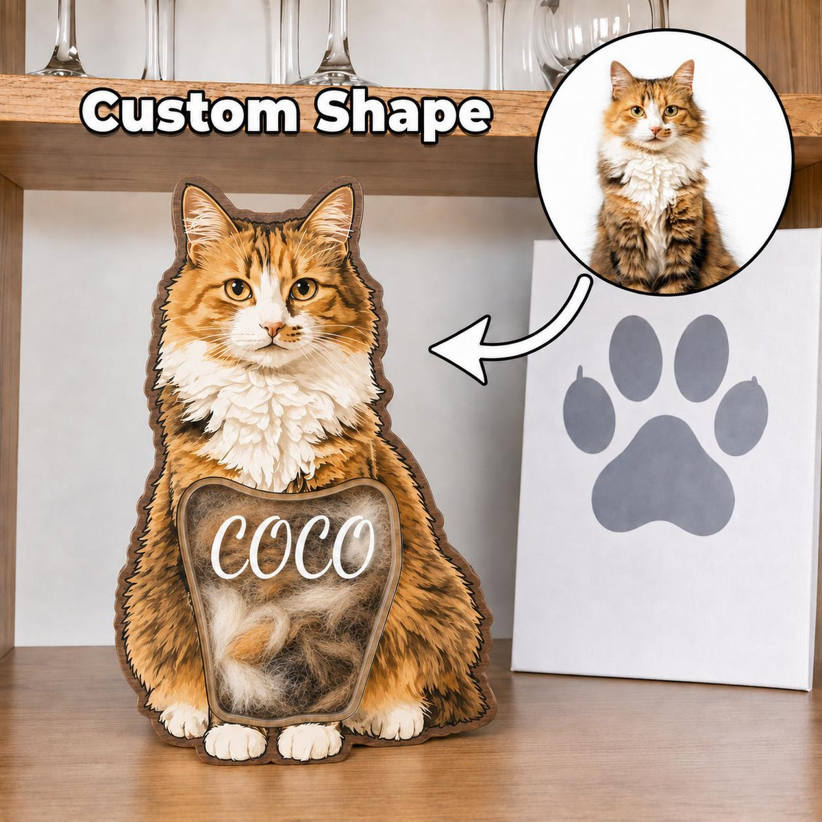 A custom-shaped wooden cat-shaped display frame featuring a printed image of a long-haired orange and white cat. The center contains a clear window with the name COCO printed in white script, filled with loose cat fur.
