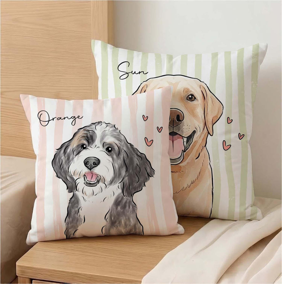 Two square throw pillows featuring illustrated dogs. The front pillow has a black and white dog with the text Orange. The back pillow features a golden-colored dog with the text Sun. Both pillows have vertical stripes and small hearts.