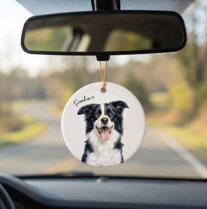 A round white ceramic ornament hanging from a gold string, featuring a detailed illustration of a black and white Border Collie with its tongue out. The name Frankie is printed in black script above the dog with a small heart.