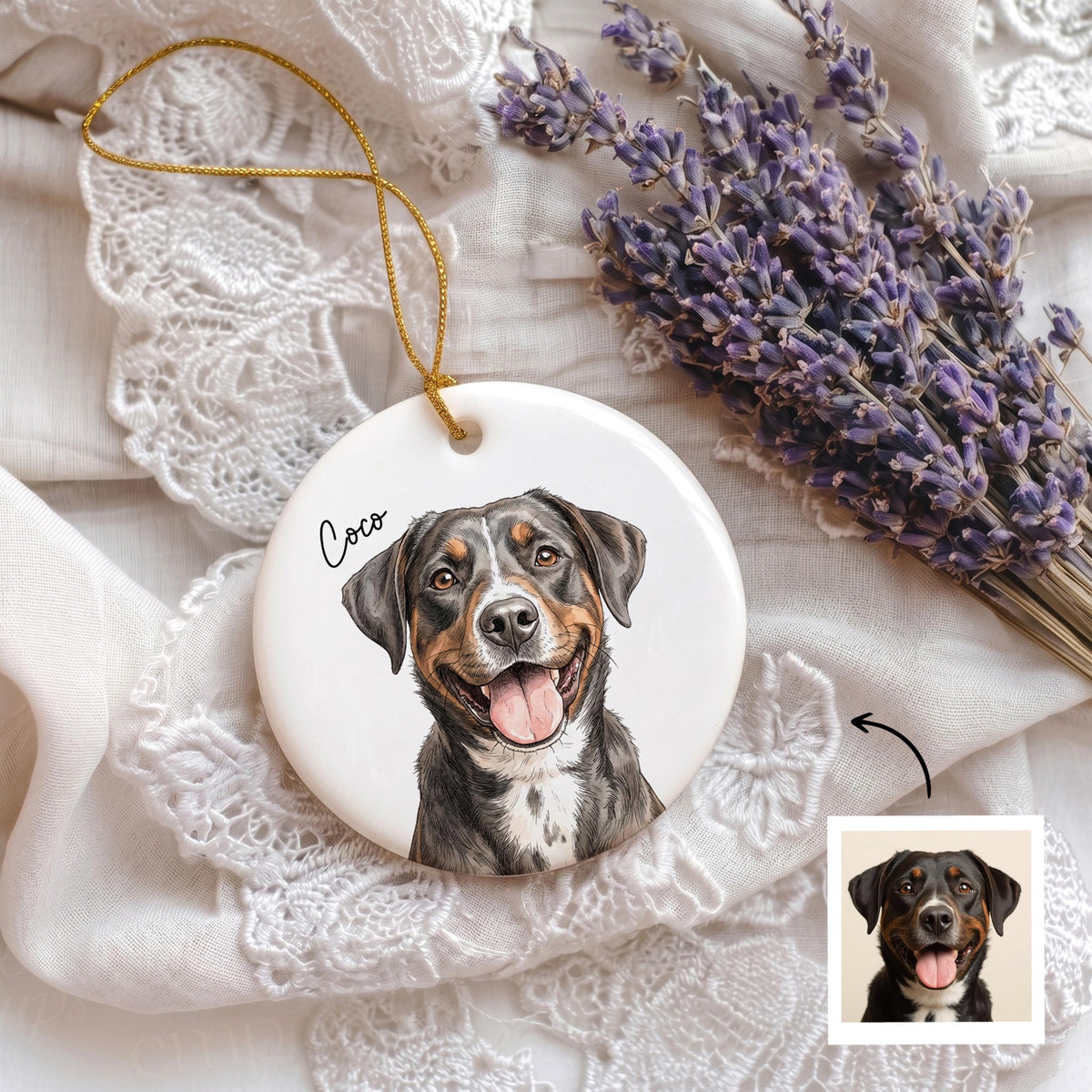 A round white ceramic ornament featuring a colorful illustration of a black, brown, and white dog with the name Coco written in black script. The ornament includes a thin gold hanging string and displays a small reference photo of the dog.
