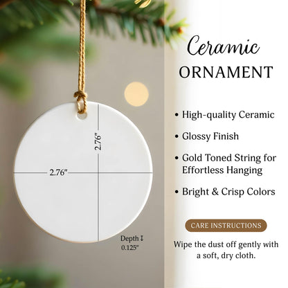 A round white ceramic ornament with a gold-toned string. Text includes Ceramic ORNAMENT, High-quality Ceramic, Glossy Finish, Gold Toned String for Effortless Hanging, Bright & Crisp Colors, CARE INSTRUCTIONS, and Wipe the dust off gently with a soft, dry cloth. Dimensions are 2.76 inches by 2.76 inches with a depth of 0.125 inches.