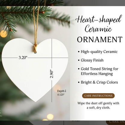 A white heart-shaped ceramic ornament with a glossy finish and a gold-toned string. Text indicates dimensions of 3.20 inches wide, 2.90 inches high, and 0.125 inches in depth. Includes care instructions to wipe dust with a soft, dry cloth.
