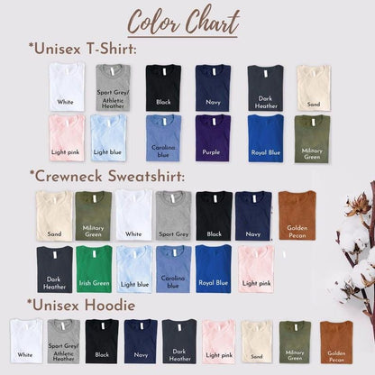 A color chart displaying various fabric colors for apparel. The chart includes sections for Unisex T-Shirt, Crewneck Sweatshirt, and Unisex Hoodie, each featuring rows of folded garments in shades like white, black, navy, sand, and pink.