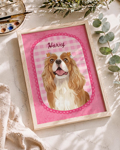 A framed print featuring a digital illustration of a brown and white Cavalier King Charles Spaniel with small yellow flowers on its head. The dog is centered within a pink gingham oval frame with the name Harry written above it.