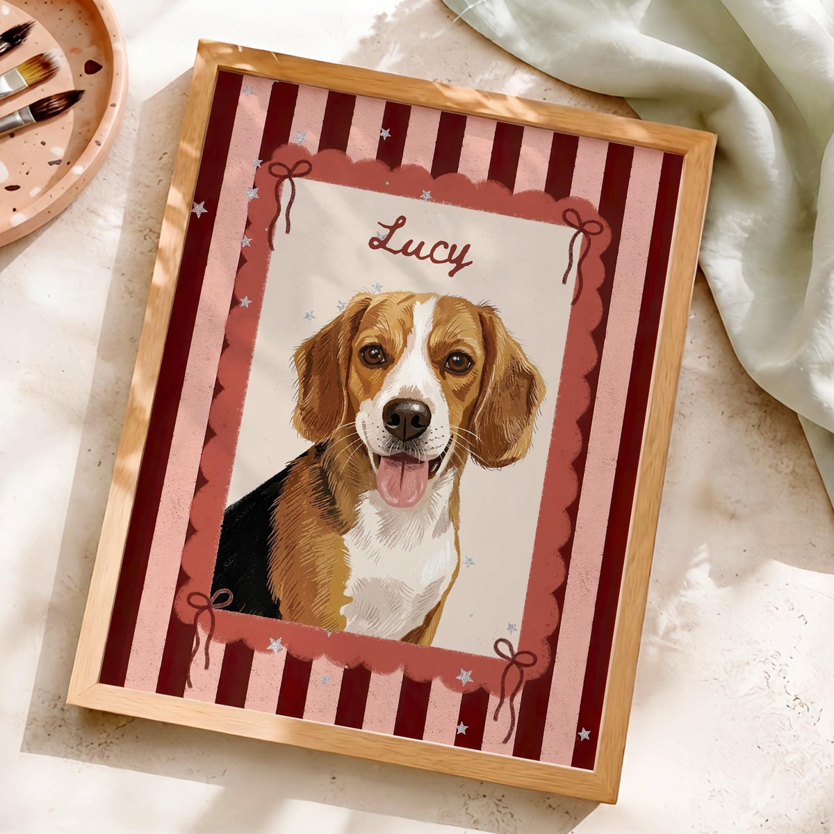 A framed portrait print featuring a brown, white, and black beagle dog with its tongue out. The illustration is set against a background of vertical dark red and light pink stripes, with a scalloped border and the name Lucy written.
