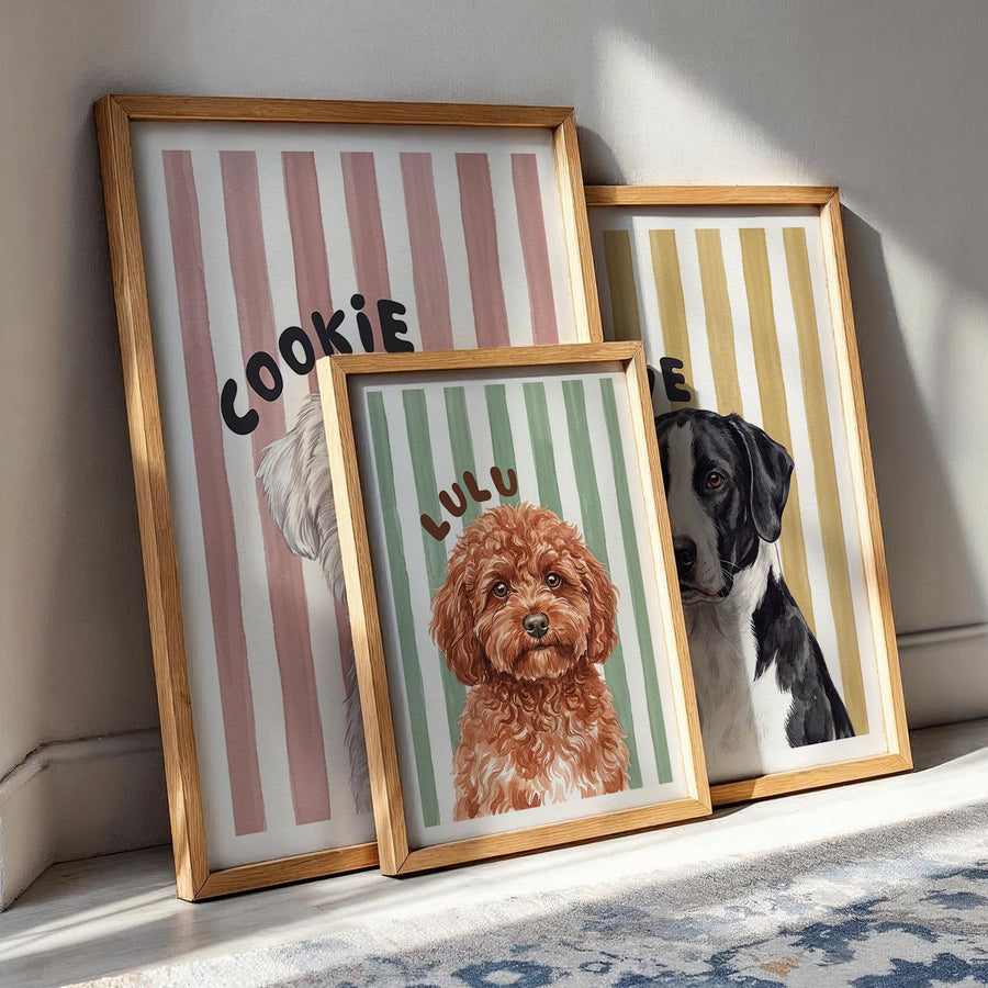 Three framed custom pet portraits in oak frames showing different sizes: watercolor dog portraits named Cookie, Lulu and Olive on pink, green and yellow striped backgrounds, personalized dog name prints from photos in a gallery arrangement.