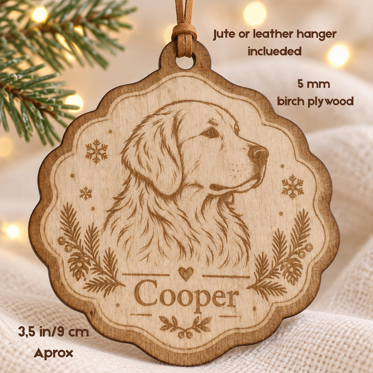 A scalloped 3.5 inch birch plywood ornament featuring a laser-engraved golden retriever portrait, snowflake accents, and pine branches. The name Cooper is engraved above a small heart. Includes a jute or leather hanger.