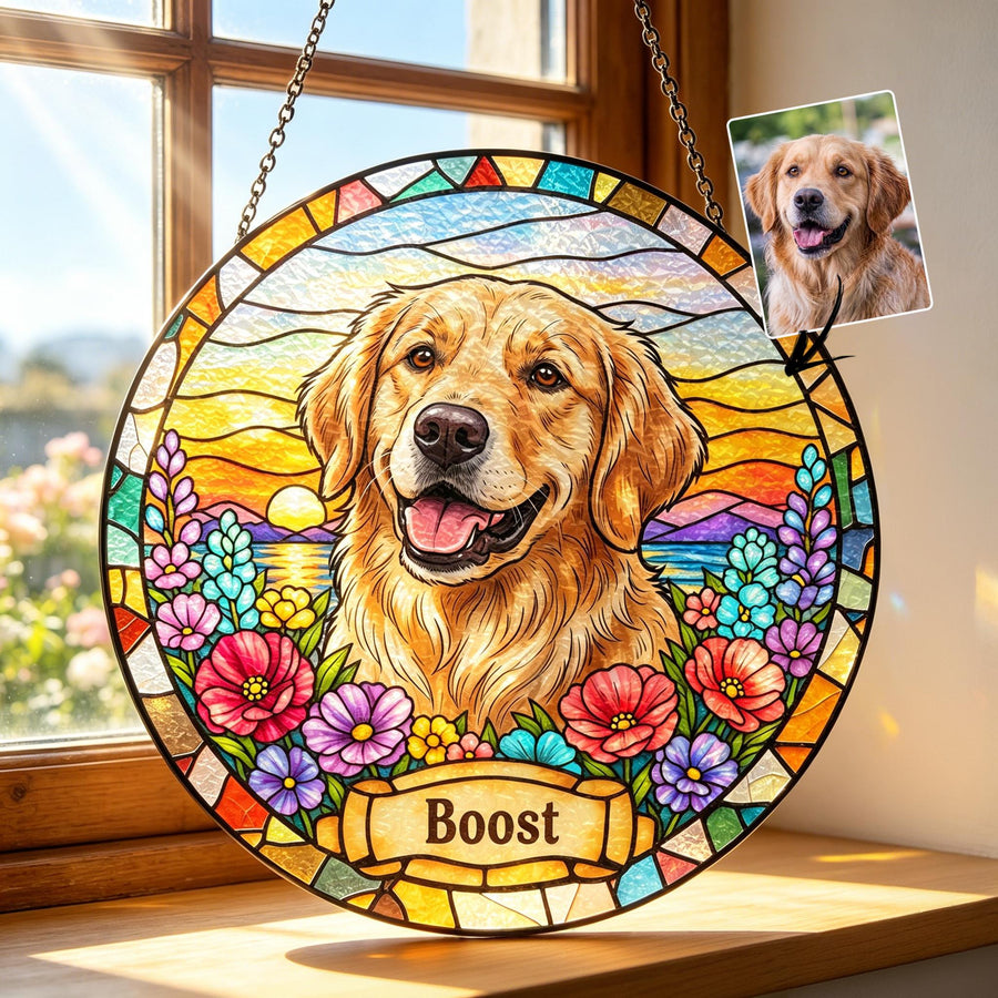 A circular stained glass suncatcher featuring a golden retriever portrait centered against a sunset landscape with colorful flowers. A banner at the bottom displays the name Boost. A small photo of the dog is attached to the top right.