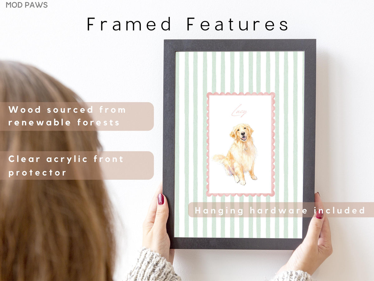 A framed print featuring a watercolor illustration of a golden retriever dog. The print has a pink border and is set against a background of vertical green and white stripes. The frame is black and the text "Framed Features" is at the top.
