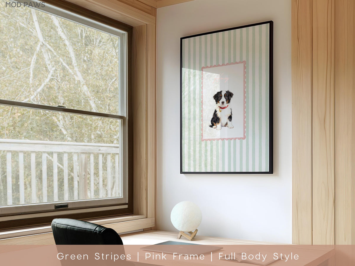 A framed print featuring a puppy with a red collar, set against a backdrop of green and white stripes. The print is in a pink frame, and the overall design is a full-body style. The artwork is displayed on a white wall.
