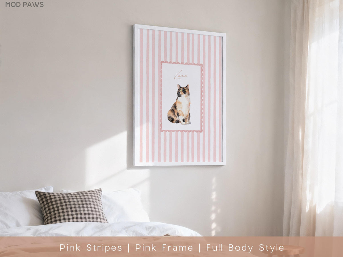 A framed print featuring a watercolor illustration of a cat. The artwork is set against a backdrop of pink vertical stripes and framed within a white border. The cat is depicted in a seated position.