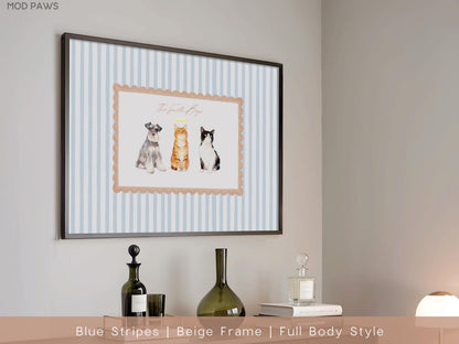 Framed artwork featuring three illustrated pets: a dog, an orange tabby cat, and a black and white cat. The artwork is set against a blue and white striped background, with a beige scalloped border and a black frame.