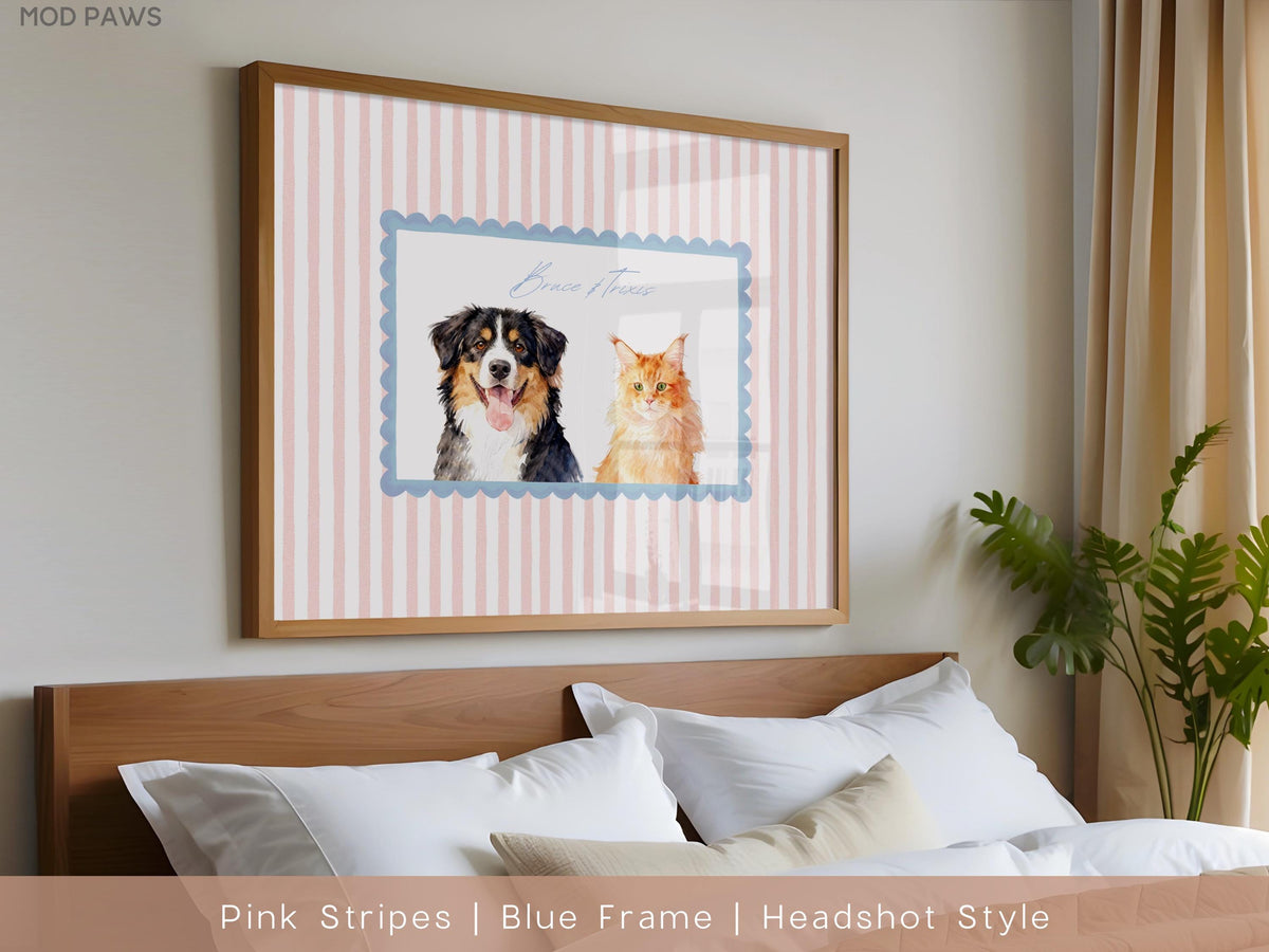 A framed print featuring a dog and a cat. The artwork is set against a pink and white striped background, with the animals inside a blue scalloped frame. The frame is a light brown color.
