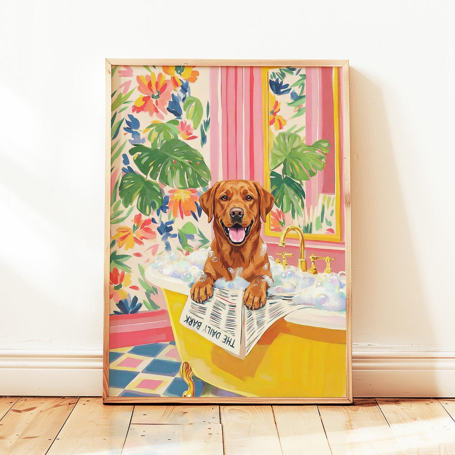 A framed print of a brown dog in a yellow bathtub filled with bubbles. The dog is holding a newspaper that reads "THE DAILY BARK". The background features floral wallpaper and a pink striped curtain.