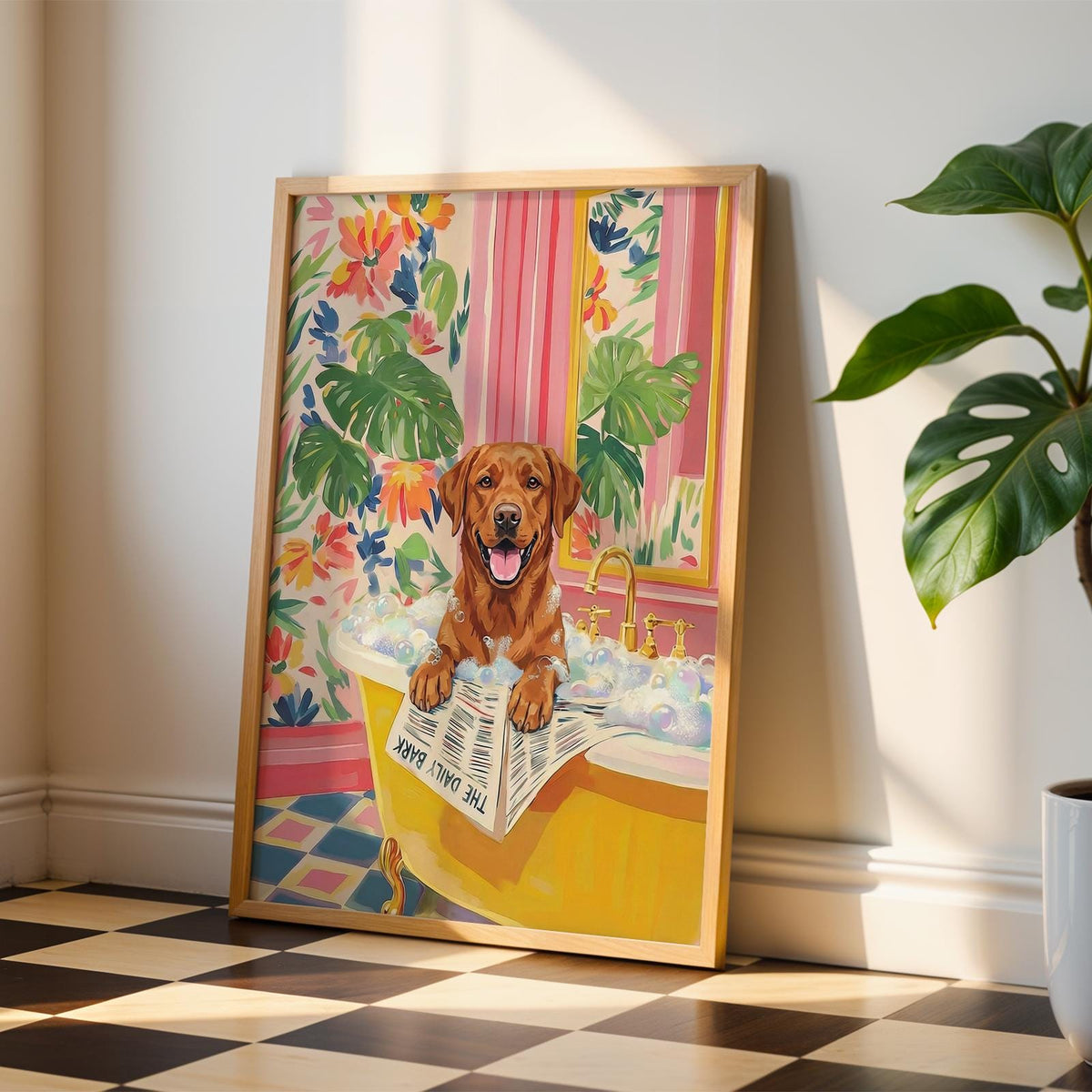 A framed print featuring a brown dog in a yellow bathtub filled with bubbles. The dog is holding a newspaper that reads "THE DAILY BARK." The background includes floral wallpaper and a window. The frame is made of light-colored wood.