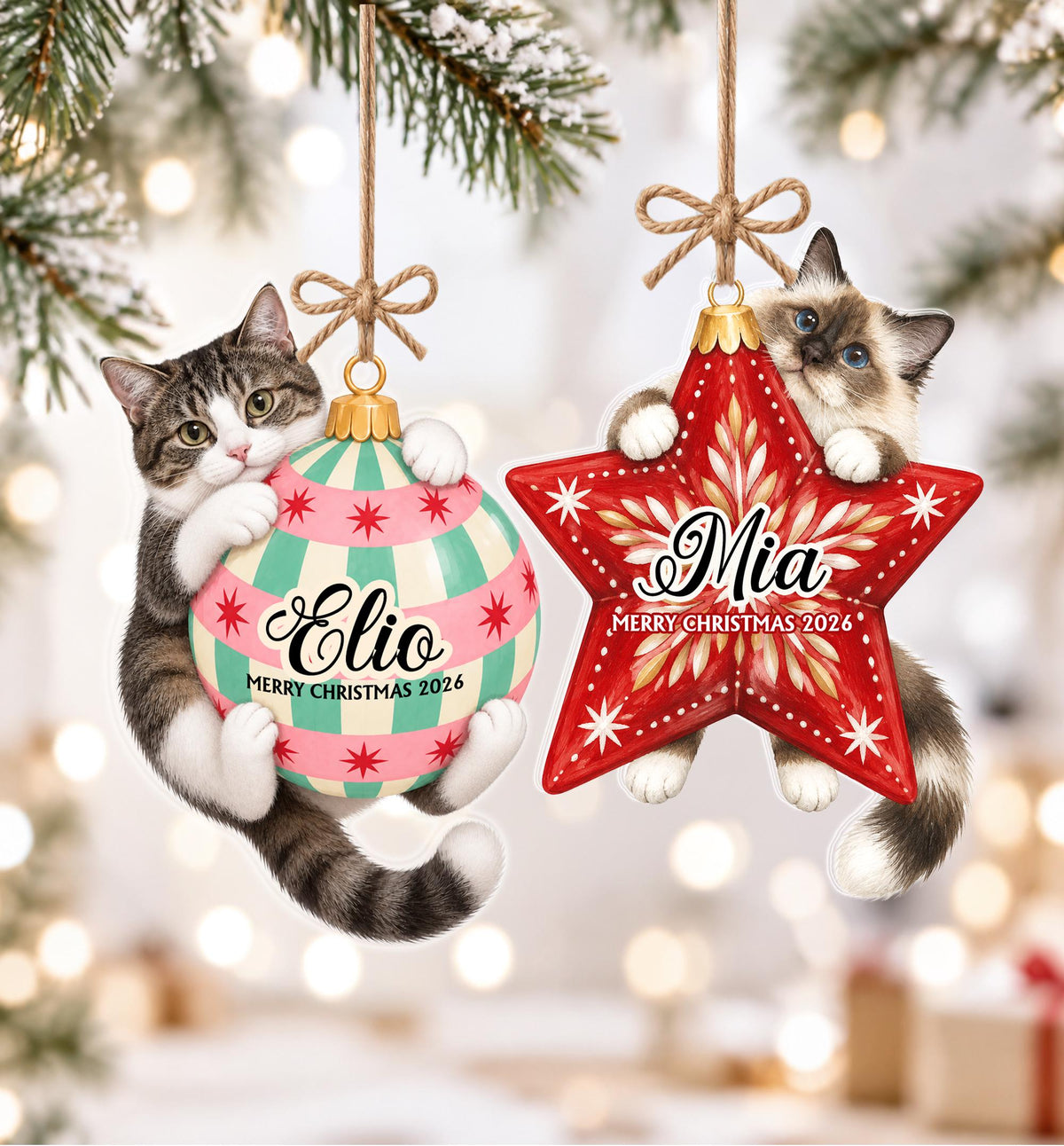Two hanging Christmas ornaments featuring cats. One is a round ball with pink and teal stripes and the name Elio, the other is a red star with the name Mia. Both ornaments include the text Merry Christmas 2026 and brown twine bows.