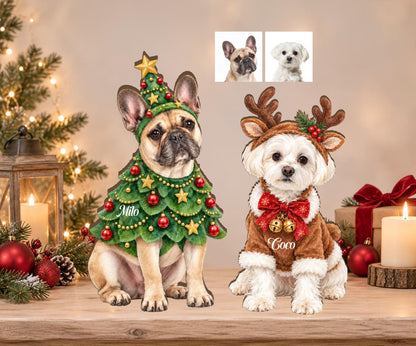 Two custom wooden dog ornaments featuring a French Bulldog named Milo dressed as a Christmas tree and a white dog named Coco wearing reindeer antlers and a brown coat with a red bow and gold bells, displayed on a wooden surface.