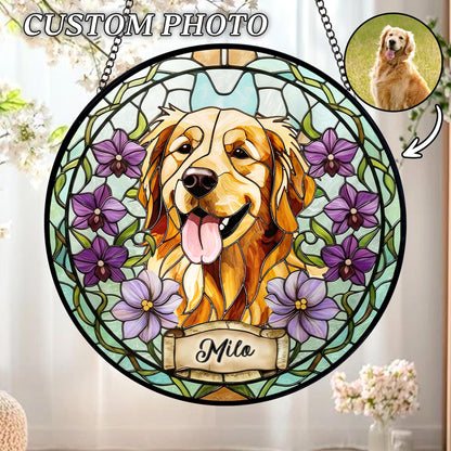 Stained glass window featuring a Golden Retriever with a happy expression, surrounded by purple flowers. The window has a black border and a chain for hanging. The name "Milo" is displayed on a banner at the bottom. The words "CUSTOM PHOTO" are at the top.
