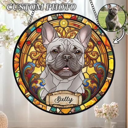 A round stained glass window featuring a gray French Bulldog with the name "Sully" on a banner. The window has a black border and is decorated with colorful, intricate patterns in shades of yellow, orange, red, and blue. The text "CUSTOM PHOTO" is at the top.
