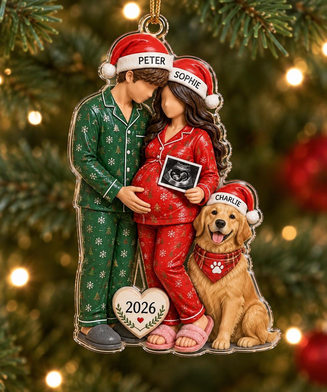 A flat acrylic Christmas ornament featuring a couple and a golden retriever wearing Santa hats. The person on the left wears green pajamas labeled PETER, the person on the right wears red pajamas labeled SOPHIE, and the dog is labeled CHARLIE.