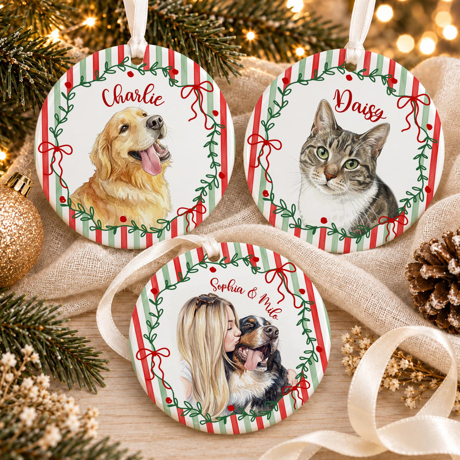 Three round ceramic ornaments featuring red and green striped backgrounds with green wreaths and red bows. One shows a golden retriever named Charlie, one a tabby cat named Daisy, and one a person with a dog named Sophia & Milo.