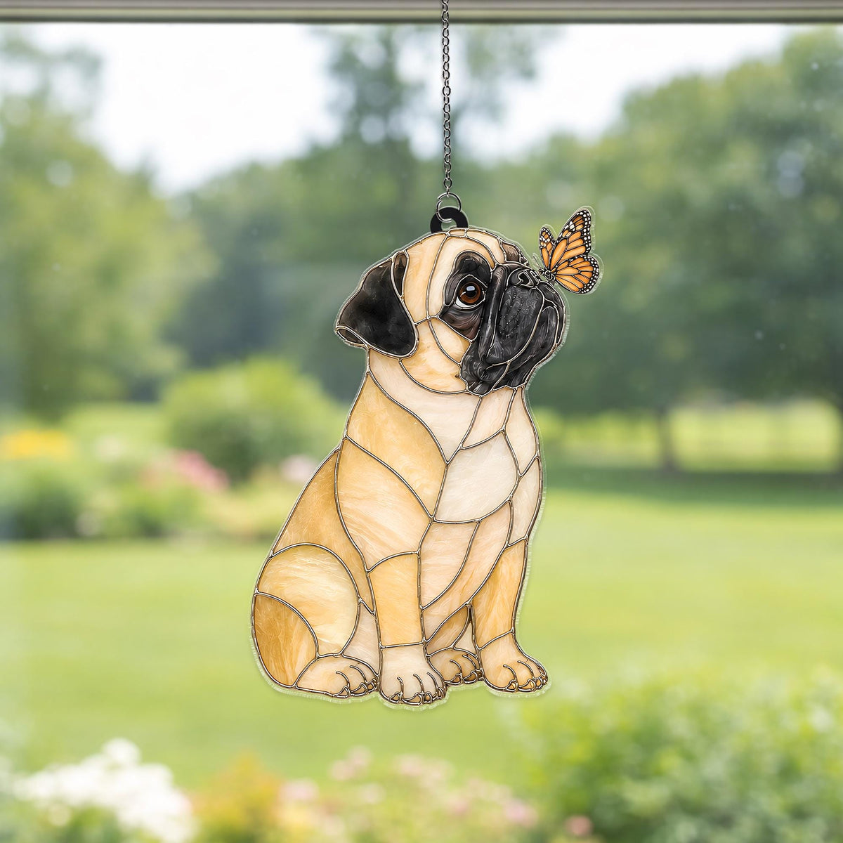A stained glass suncatcher featuring a tan pug with a black muzzle and ears, sitting in profile. A small orange and black monarch butterfly is perched on the pug's nose. The piece is constructed with dark metal solder lines.