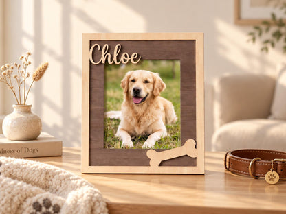 A rectangular wooden picture frame with a light wood outer border and a dark wood inner frame. The name Chloe is cut out in light wood script at the top left, and a light wood bone shape is attached at the bottom right corner.