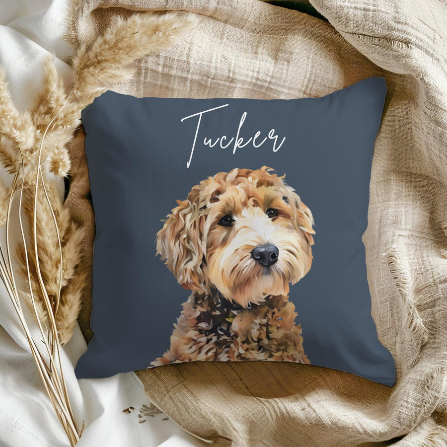 A blue throw pillow with a brown and white dog illustration and the name "Tucker" written in white script.