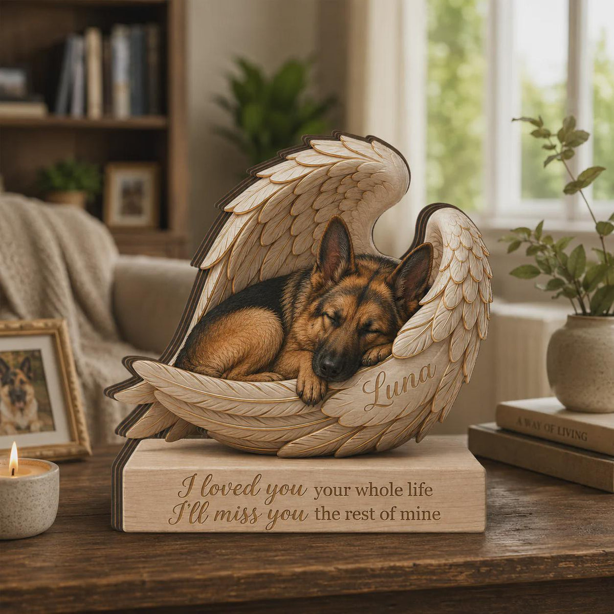 A wooden memorial sculpture featuring a sleeping German Shepherd dog nestled within a pair of carved angel wings. The name Luna is engraved on the wing, and the base features the text: I loved you your whole life I'll miss you the rest of mine.